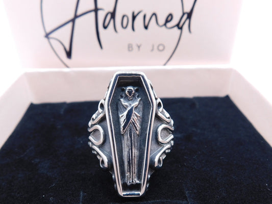 Resting in peace coffin ring